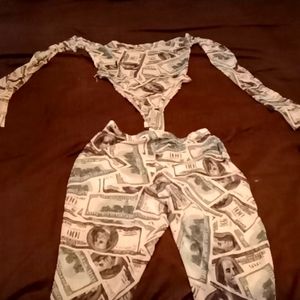 This outfit is a Body suit and the color is green and white with $100 signs